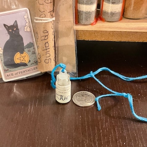 Tiny Amulet Bottle with Juniper Leaves, Orange Peel or Basil. Good luck, protection, cleansing, creativity.