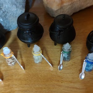 One Tiny Bottle of Magick Potion Ingredient Herb Element.  For mini altar or carrying as amulet. Comes with teeny tiny spoon.
