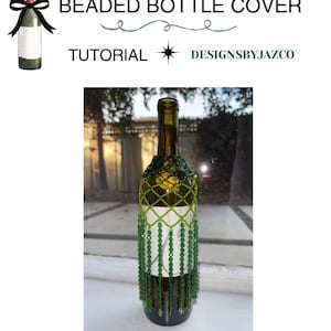 May include: A glass wine bottle adorned with a decorative beaded cover featuring a green lattice pattern at the top and long, dangling green beaded fringe strands. The text BEADED BOTTLE COVER TUTORIAL DESIGNSBYJAZCO is displayed above the bottle.