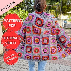 May include: A grey crochet cardigan with a hood, featuring a colourful granny square pattern in shades of pink, orange, green, and purple. The cardigan is shown being worn by a person.