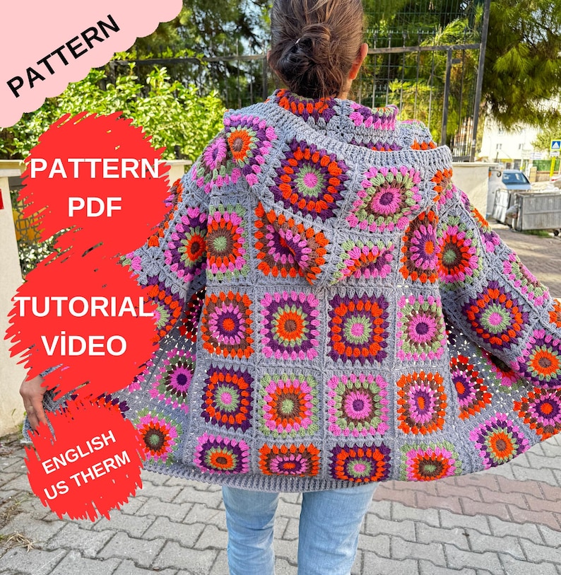 May include: A gray crochet cardigan with a hood, featuring a colorful granny square pattern in shades of pink, orange, green, and purple. The cardigan is shown being worn by a person.