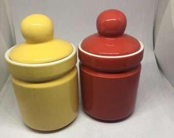 Ceramic lidded honey sugar pots. Vibrant red and yellow glaze.