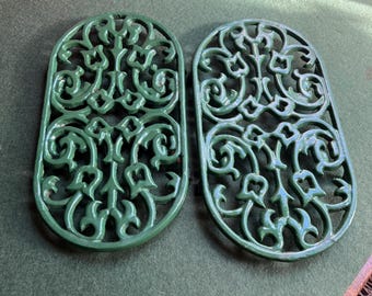 Vintage cast iron trivets. Large Oval green 4 footed trivets. 2 available. Sold separately.