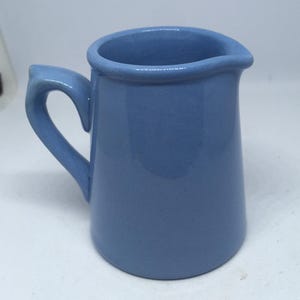 Vintage blue ceramic creamer milk jug. Stamped Dudsons Hanley Made specially for for Coopers & Sons Stores Ltd.