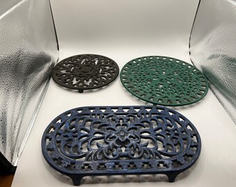 Vintage cast iron trivets. 3 available.