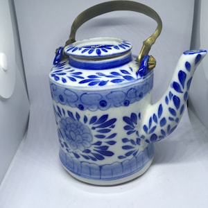 Unusual Vintage ceramic blue and white lidded tall teapot Brass handle. Hand painted. Blue and White floral and leaf hand painted design.