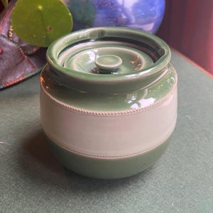 Vintage Antique Tobacco Jar Storage Pot Humidor. Stamped Aonian Pottery made in England. Green and cream glaze.