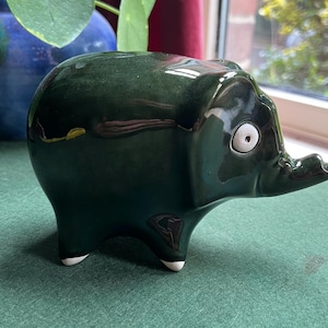 Quirky vintage Wellow Pottery ceramic stylised elephant figurine. Trunk up lucky elephant. Green glazed white feet. Collectible elephant