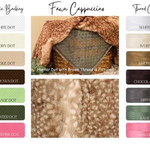 May include: A fawn-colored baby blanket with a brown and white spotted pattern. The blanket is folded and placed in a wicker basket. The blanket is available in a variety of colors and can be personalized with a name. The text "Hunter Dot with Brown Thread is Pictured" is displayed below the blanket.