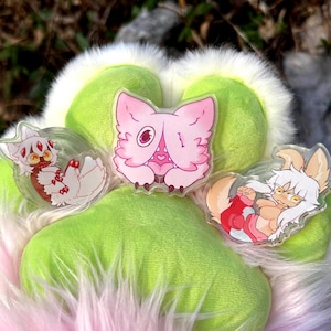 May include: A white ceramic mug with a black handle and the text "But First, Coffee" in a black, bold font. The mug is sitting on a wooden surface. The mug is approximately 4 inches tall.