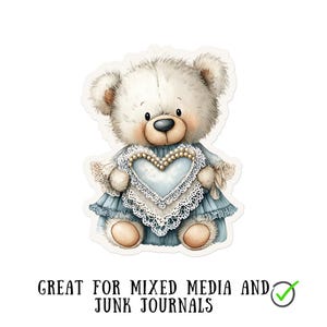 May include: A sticker featuring a watercolor illustration of a teddy bear. The bear is white with a blue dress and a heart-shaped lace design. The text "GREAT FOR MIXED MEDIA AND JUNK JOURNALS" is at the bottom.