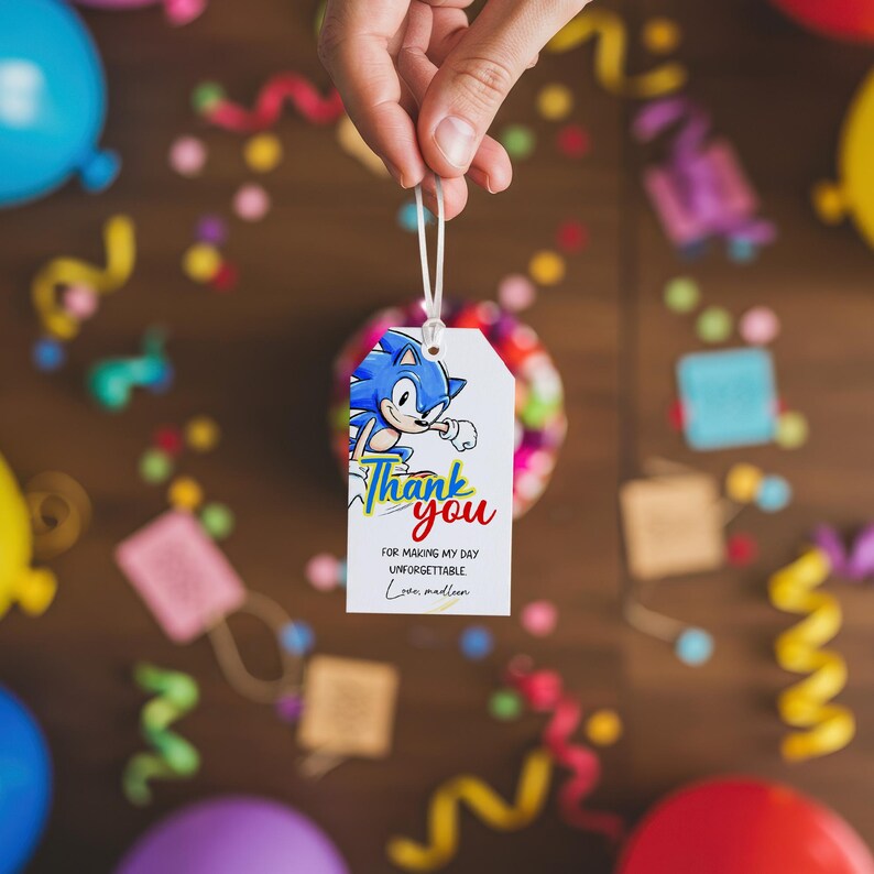 May include: White gift tag featuring a blue cartoon hedgehog character and the words "Thank You" in colorful text. The tag also includes the text "For making my day unforgettable".