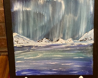 May include: A painting depicting a snowy mountain range with a blue and green aurora borealis in the sky above a frozen lake.