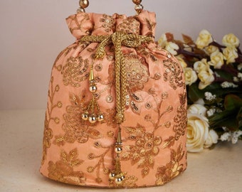 Banjara orange Potli bag with golden embroidery, threadwork, drawstring, Sequin work and Designer Pattern, for Wedding.