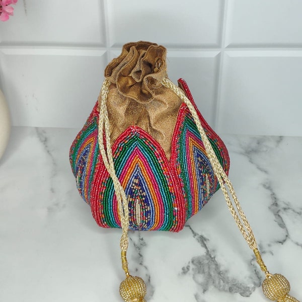 Rainbow Potli bag, handbag with Meticulous Design, Versatile Textured work and Woven Tassels for Fashionable and Functional outfits.