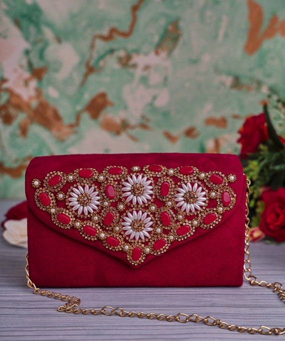Red designer clutch bag hotsell