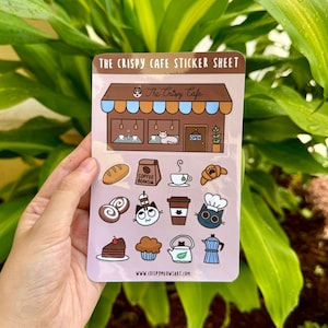 Stickervel krokant café, coffeeshopsfeer, koffiekatten, schattige laptopsticker, katten en koffie, gezellige cafésfeer, cadeau voor koffieliefhebber