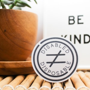 Disabled Does Not Equal Disposable Vinyl Sticker | White/Clear | 2 Inch Circle | Disability Pride & Awareness | Laptop Water Bottle Sticker