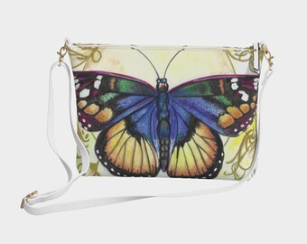 May include: A white crossbody bag featuring a vibrant butterfly illustration. The butterfly has blue, yellow, green, and orange wings. The bag has a white strap and gold-colored hardware. The background is a soft yellow with floral accents.