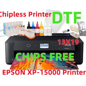 May include: Black Epson XP-15000 printer with "Chipless Printer DTF" text. Includes ink bottles, ink cartridges, and other accessories. The printer supports 13x19 inch printing and has "CHIPS FREE" text.