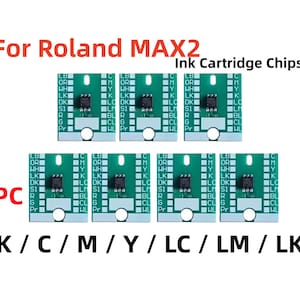 May include: Seven green ink cartridge chips for Roland MAX2 printers. Each chip has a small black component and various white text labels. The chips are labeled K, C, M, Y, LC, LM, and LK.