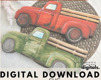 May include: Two vintage-style wooden truck cutouts, one red and one green, with a distressed paint finish. The red truck has a white background with the text "Geo Dupuis & Sons Mammoth" on the side. The green truck has a white background with the text "Jellybean Market digitals." on the side. Both trucks have a wooden bed and wheels.