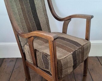 May include: A wooden armchair featuring a high back and seat upholstered in a textured fabric with vertical stripes in shades of brown, tan, and olive green. The chair has curved wooden armrests and four straight legs.