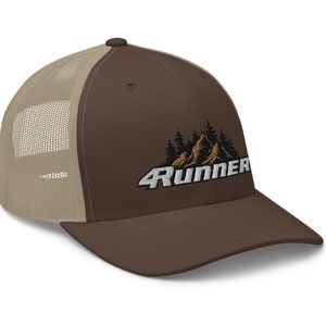 May include: Brown and beige trucker cap featuring the word "4Runner" in white, with a mountain and tree design. The cap has a curved peak and a mesh back.