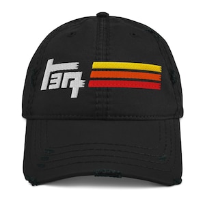 May include: Black distressed baseball cap featuring white embroidered text and a horizontal stripe design in yellow, orange, and red. The cap has a curved peak and a worn look.