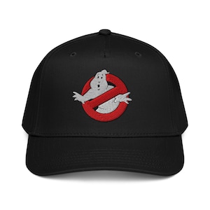 May include: Black baseball cap with an embroidered Ghostbusters logo. The logo is a white ghost inside a red circle with a red line through it. The cap has a curved peak and a button on top.