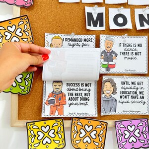 May include: A corkboard featuring inspirational quotes from notable Hispanic figures. The quotes are displayed on colourful cards with illustrations of the individuals. The corkboard is decorated with colourful paper cutouts.