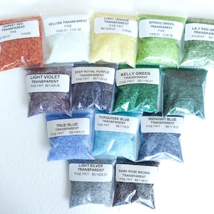 May include: An assortment of transparent fine frit glass in small, clear plastic bags. Colors include garnet red, yellow, light orange, spring green, lily pad green, light violet, deep royal purple, kelly green, true blue, turquoise blue, midnight blue, light silver, and dark rose brown.