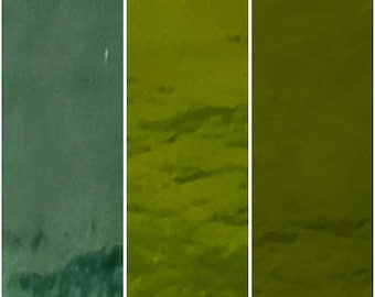 May include: A triptych of abstract images. The first panel is a dark teal, the second and third panels are shades of olive green. The images have a textured appearance, with subtle variations in tone and pattern. The overall effect is one of depth and visual interest.