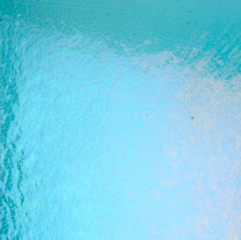 May include: Abstract, textured background with a gradient of light blue and white. The surface has a subtle, rippled effect, creating a sense of depth and movement. The overall aesthetic is clean and minimalist.