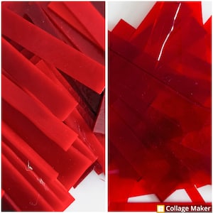 May include: A pile of red glass pieces, some are long and thin, others are shorter and wider. The glass is translucent and has a slight shimmer.