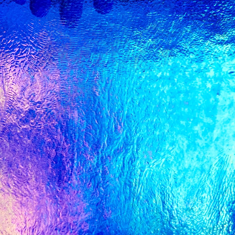 May include: Abstract image with a gradient of blues and purples. The surface has a rippled texture, creating a sense of depth and movement. The colors transition smoothly, with darker shades at the top and lighter hues towards the bottom.