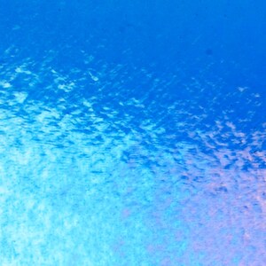 May include: Abstract watercolor painting with a gradient of blues and hints of pink. The texture suggests a cloudy or underwater effect, with variations in color intensity creating depth.