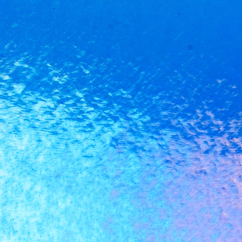 May include: Abstract watercolor painting with a gradient of blues and hints of pink. The texture suggests a cloudy or underwater effect, with variations in color intensity creating depth.