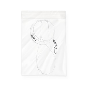 May include: Clear plastic bag containing fishing leaders. The leaders are made of thin, clear wire with black swivels and a hook clasp. The bag has a zip closure.