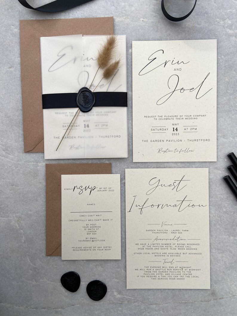 May include: Wedding invitation suite featuring a translucent invitation with the names "Erin and Joel" in elegant script, a black ribbon, and a wax seal. Includes RSVP and guest information cards, all in a neutral color palette. Dried floral accents add a natural touch.