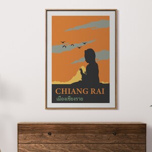 K&ouml;nnte beinhalten: Ein Vintage-Reiseposter mit der Silhouette einer Person vor einem Sonnenuntergang. Das Poster ist in den Farben Orange, Gelb und Grau gehalten und zeigt den Text "CHIANG RAI" und thail&auml;ndischen Text.