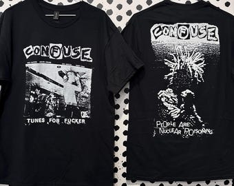 May include: A black short-sleeved t-shirt featuring white graphic prints on the front and back. The front displays a band photo with the text CONFUSE and TUNES FOR FUCKER. The back features a spiky-haired figure and the text PEOPLE ARE NUCLEAR POISONING.
