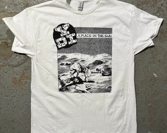 May include: White t-shirt featuring a black and white graphic print of a band called "YDI" and the text "A Place In The Sun".