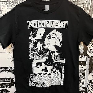 May include: Black t-shirt with a white graphic design. The design includes the text "NO COMMENT" at the top, with a collage of images and the word "downsided" below. The words "COMMON SENSELESS" are printed vertically on the right side.