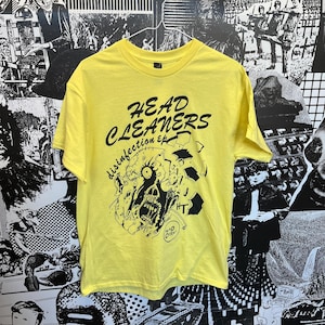 May include: Yellow t-shirt with a black graphic print of a monster with gears and the text "HEAD CLEANERS disinfection ep".