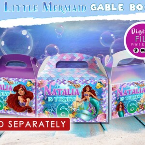May include: Three gable boxes with a mermaid theme. Each box features a different mermaid illustration, the name "Natalia", and the number "6". The boxes are purple, blue, and iridescent, with the text "The Little Mermaid Gable Boxes" at the top.