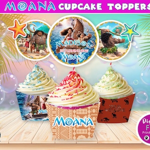 May include: Moana cupcake toppers featuring a colourful design with Moana, Maui, and Pua. The toppers include the text "Moana" and "Madison is turning one".
