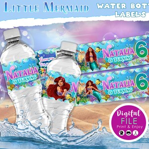 May include: Water bottle labels featuring a mermaid theme. The labels have the text "Natalia is Turning" and the number "6". The design includes illustrations of mermaids, fish, and underwater elements. The words "The Little Mermaid" and "Water Bottle Labels" are at the top.