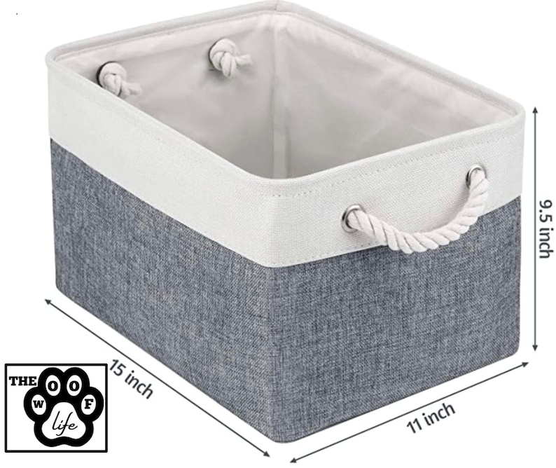 May include: A grey and white fabric storage bin with rope handles. The bin measures 15 inches wide, 11 inches long, and 9.5 inches high.