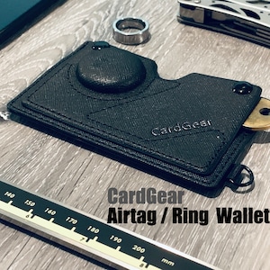 Cartera Airtag/Cartera de aro con ranura para llaves y clip extraíble para billetes, color negro, con bloqueo RFID y piel sintética vegana. Ideal para él y para ella.